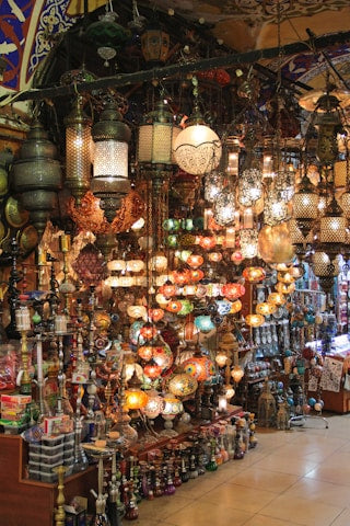 Colorful array of hanging lanterns and decorative items in a market.
